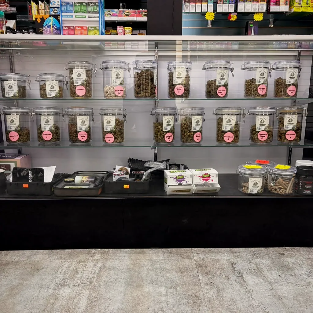 Flower bar with labeled strain jars at Way~Up Smoke