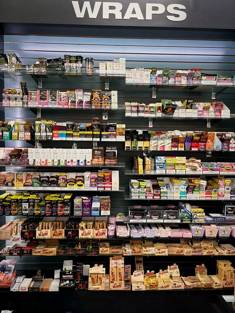 Wall of rolling papers and wraps at Way~Up Smoke